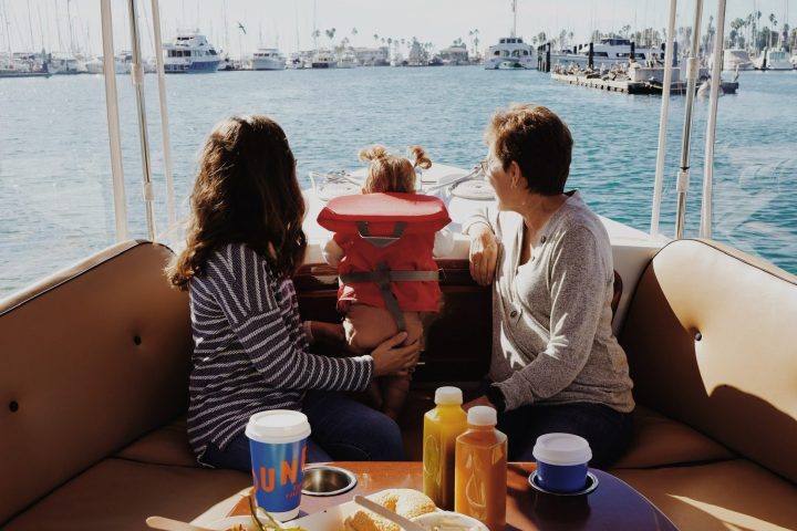 a woman sitting at a table in front of a body of water