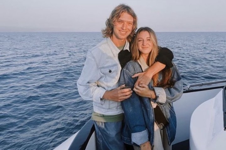 a person standing next to a body of water